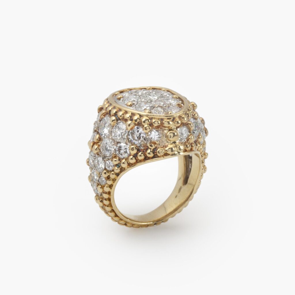 Een achttien karaat geelgoud en platina ring bezet met briljant geslepen diamanten, waartussen bolletjes, door Van Cleef & Arpels, Frankrijk, ca 1970.